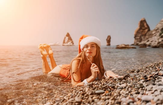 Woman travel sea. Happy tourist taking picture outdoors for memories. Woman traveler looks at the edge of the cliff on the sea bay of mountains, sharing travel adventure journey.