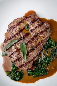 beef steak with gravy and herbs