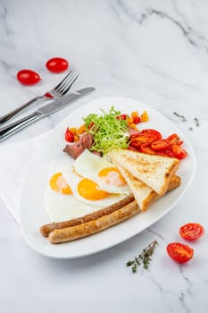 scrambled eggs with vegetables, cherry tomatoes, bread, herbs and sausages