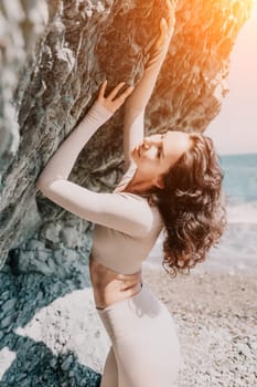 Happy young attractive brunette woman in red swimsuit, on the beach and sea background. Holiday vacation and travel concept.