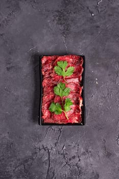 raw beef with green parsley.Garnish. View from above. Chinese cuisine, hotpot ingredient