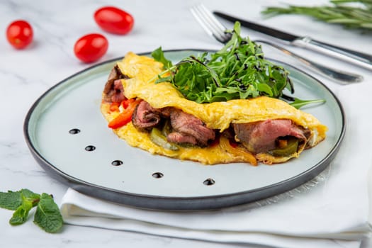 Breakfast of eggs with meat, herbs and drops of sauce