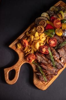 fried pieces of steak with vegetables on the grill