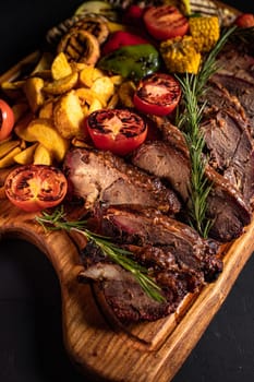 fried pieces of steak with vegetables on the grill