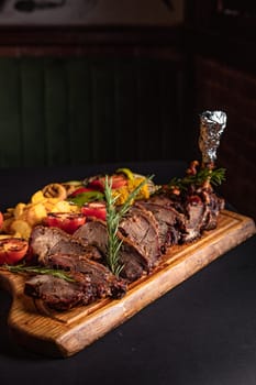 fried pieces of steak with vegetables on the grill