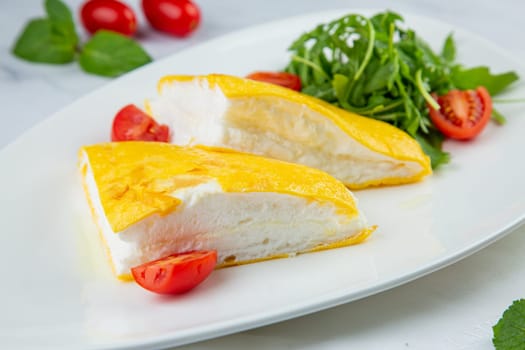 French tall omelette with arugula and cherry tomatoes