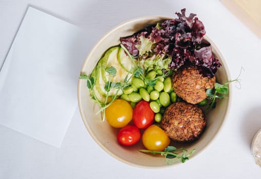 meatballs with beans, herbs, cherry tomatoes and sauce