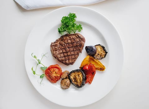 beef steak with grilled vegetables and herbs