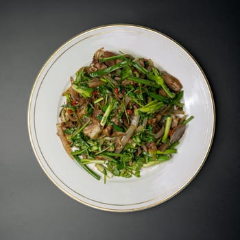 fried pork with herbs and vegetables