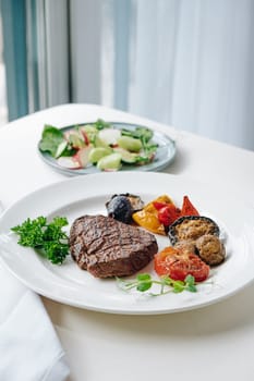 beef steak with grilled vegetables and herbs