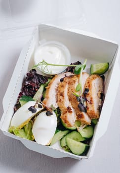 pieces of chicken with vegetables, herbs and sauce