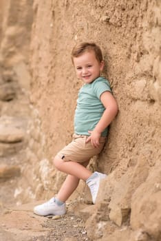 Smiling boy exploring in woods.