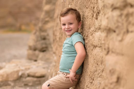 Smiling boy exploring in woods.