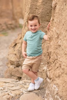 Smiling boy exploring in woods.