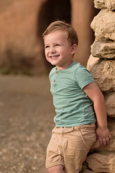 Smiling boy exploring in woods.