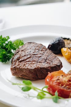 beef steak with grilled vegetables and herbs