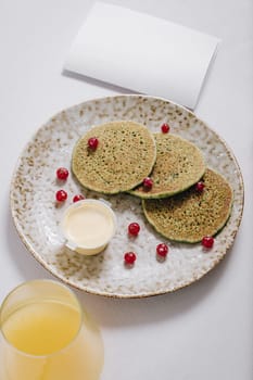 pancakes with berries and a glass of juice