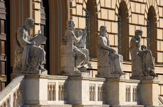 ... in front of the Munich State Library,from left to right: Thucydides (historiography),Homer (geang/poetry),Aristotle (political philosophy),Hippocrates (natural history/medicine)