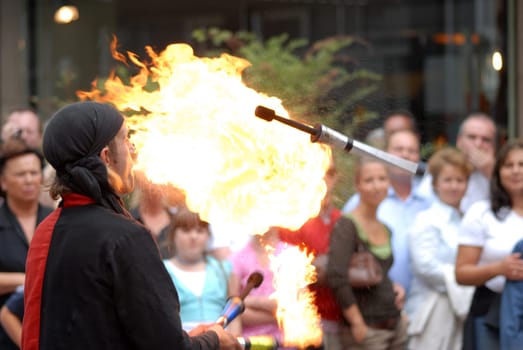 Fire-breathing juggler with audience