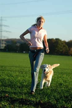 Young woman running with dog