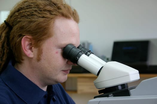 Man working with microscope