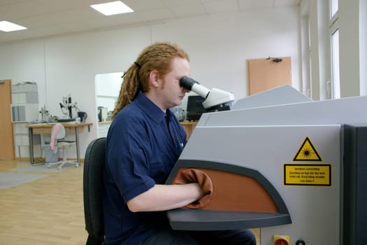 Man working with microscope
