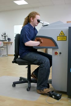 Man working with microscope