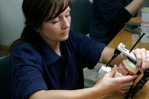 Young woman in dental laboratory