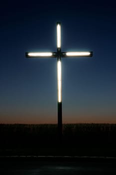 Illuminated cross in the sunset
