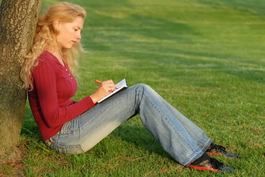 Young woman taking notes