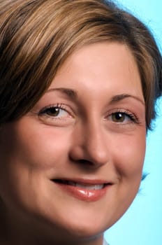Portrait of a young woman against a blue background