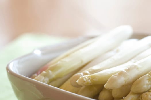fresh asparagus in porcelain bowl
