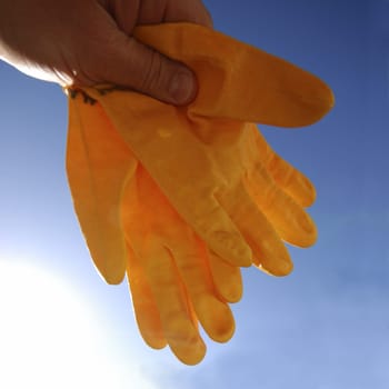 Rubber gloves against the sky