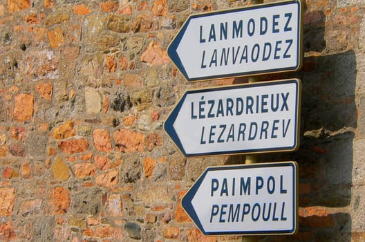 On the signs,the village name is written in French at the top,and in Breton below. In Brittany,Breton is being learned again at school. Greetings :-)