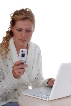 Young woman with laptop and mobile phone