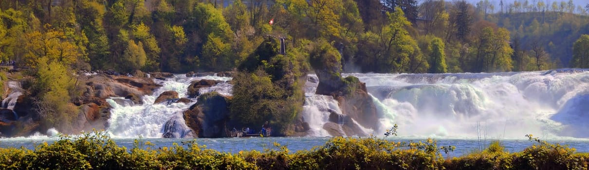 The Rhine Falls,the largest waterfall in Europe,offers visitors a magnificent spectacle. Over a width of 150 m and a height of 23 m,700 cubic meters of water per second fall over the rocks at the average water flow of the Rhine. From the Rhine Falls