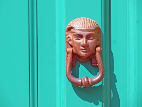 "A door knocker is used by the visitor asking for admission to draw attention to himself."""