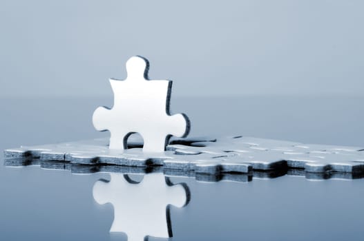 A piece of the puzzle in the partially completed puzzle stands upright - dances out of line. Symbolic image
