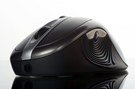Wireless mouse cropped against a white background with reflection