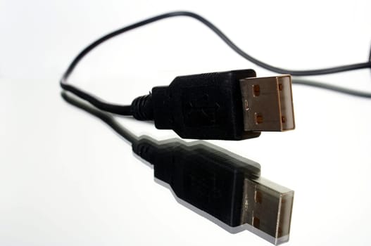 USB plug with cable exposed against white background with mirroring