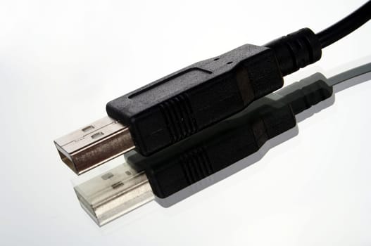USB plug with cable exposed against white background with mirroring