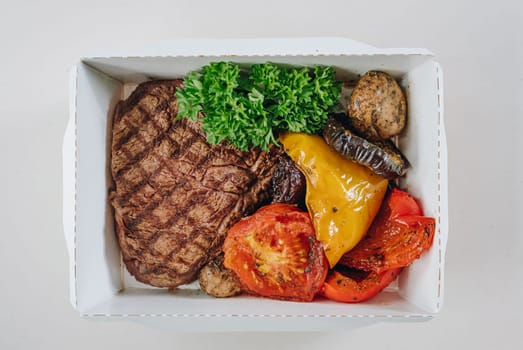 food in containers. proper nutrition, daily diet, weight loss. veal steak with grilled vegetables.