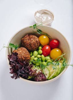 meatballs with beans, herbs, cherry tomatoes and sauce