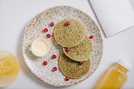 pancakes with berries and a glass of juice