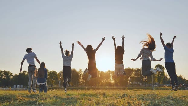 Merry friends bouncing around at sunset