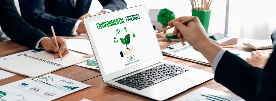 Business people in green corporate company planning eco-friendly and environmental conservative to reduce CO2 and implement net zero policy in meeting room with eco idea on laptop screen. Trailblazing