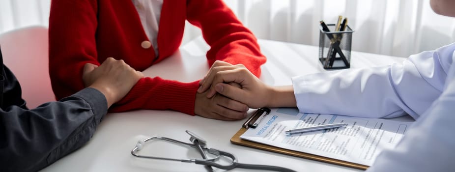 Couple attend fertility or medical consultation with gynecologist at hospital as family planning care for pregnancy while doctor and husband consoling young wife through appointment. Panorama Rigid