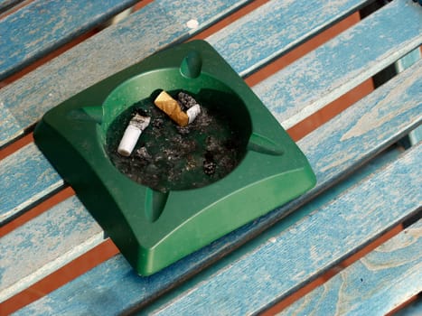 Ashtray on blue table