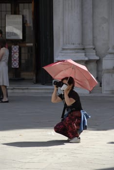 Photographer with umbrella