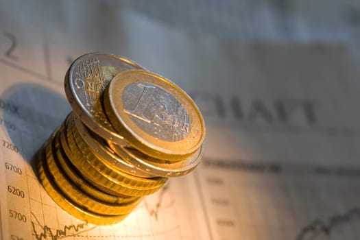 Stack of euro coins on a newspaper
